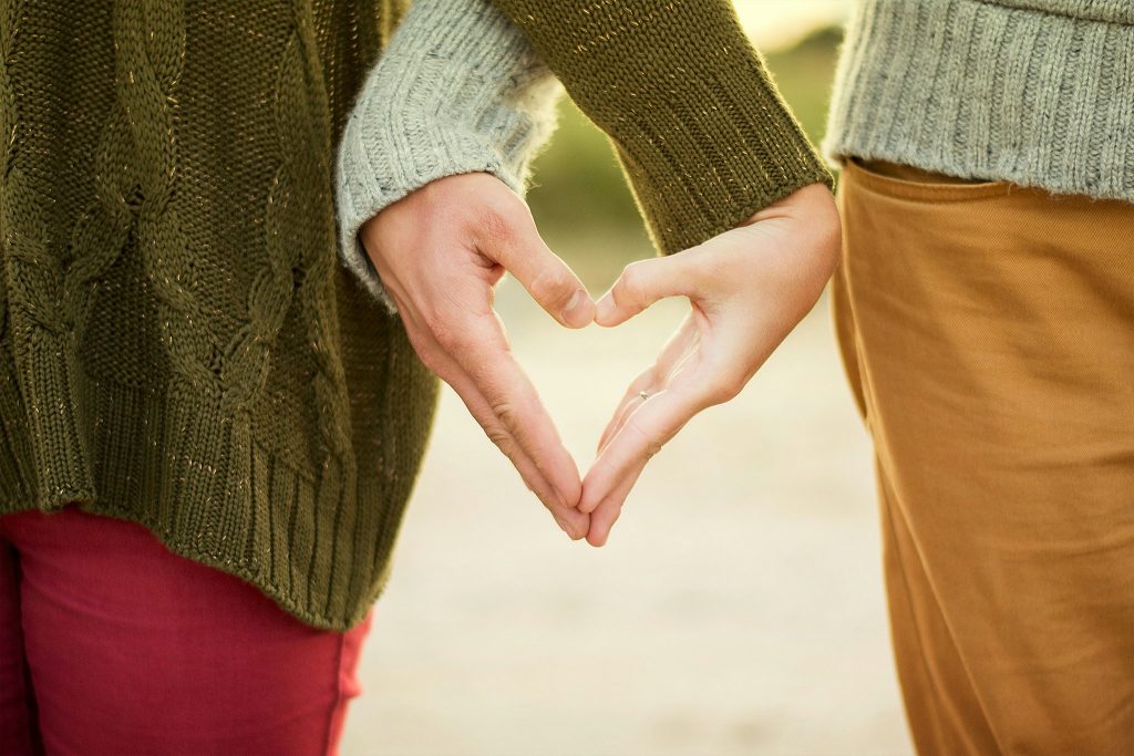 a couple of hands making a heart shape