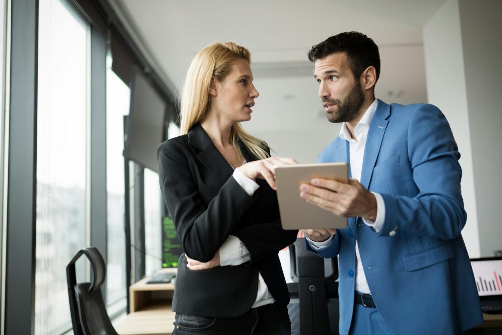 a man and woman looking at a tablet