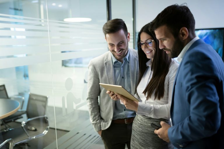 a group of people looking at a tablet