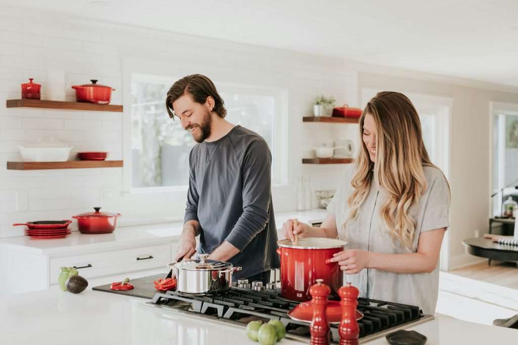 a man and woman cooking in a kitchen