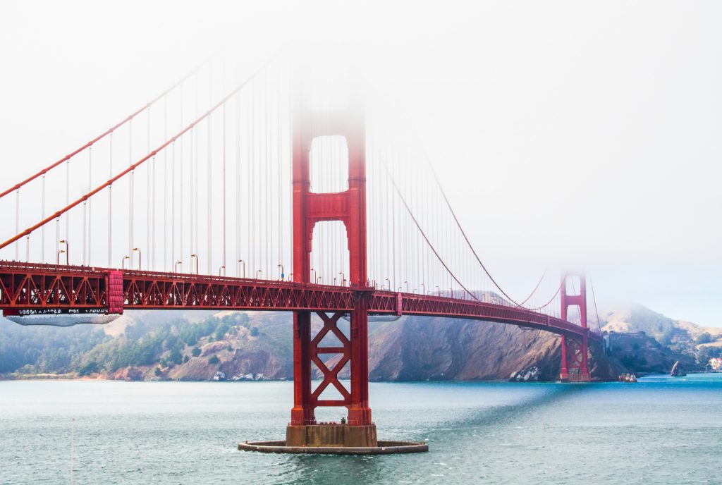 a bridge over water with fog