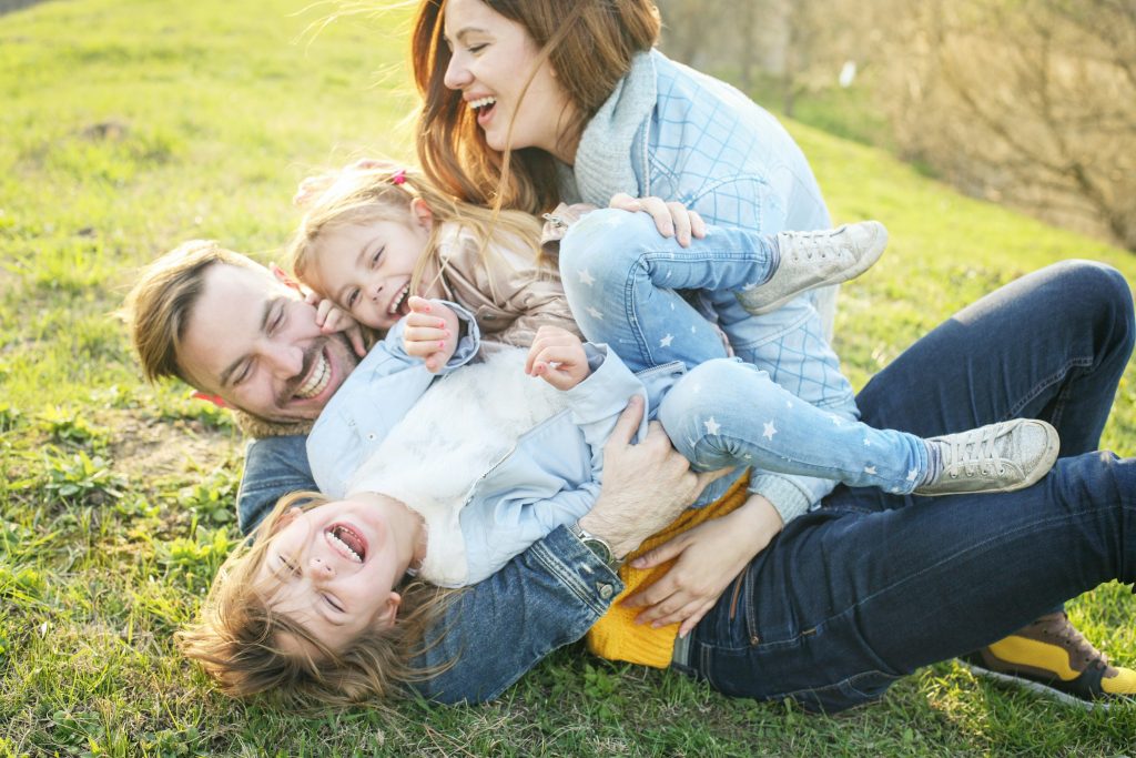 a man and woman holding two children