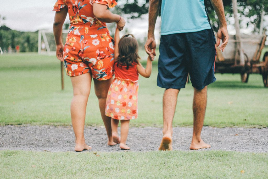 a group of people walking with a child