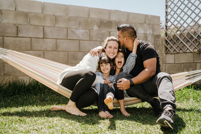 a group of people sitting on a hammock