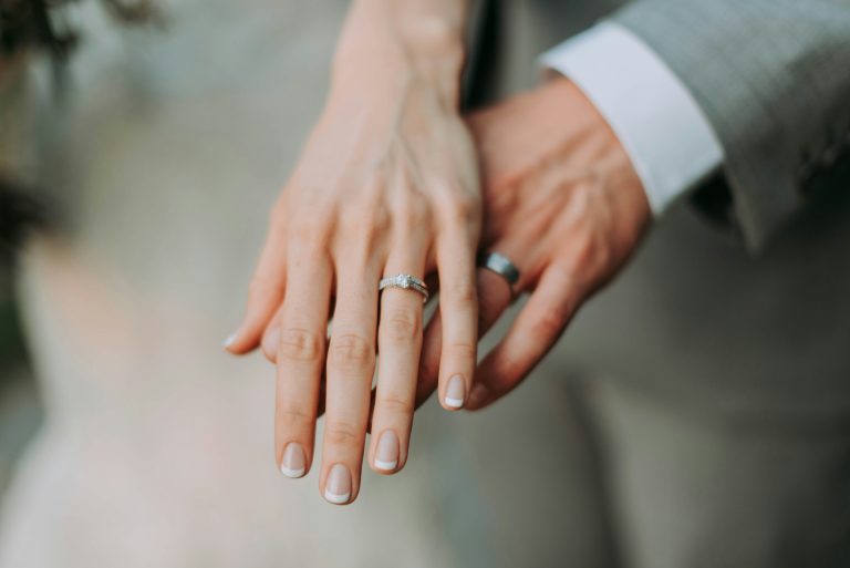 a close up of hands with rings