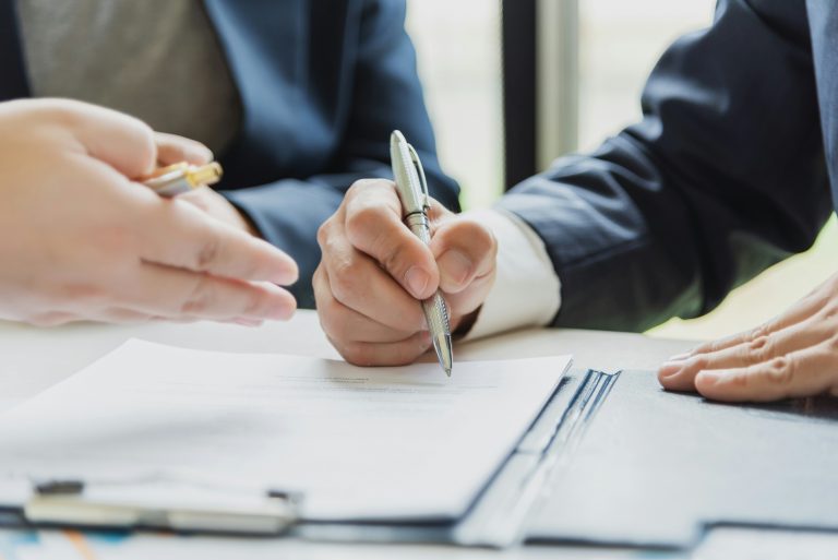 a close-up of a person holding a pen