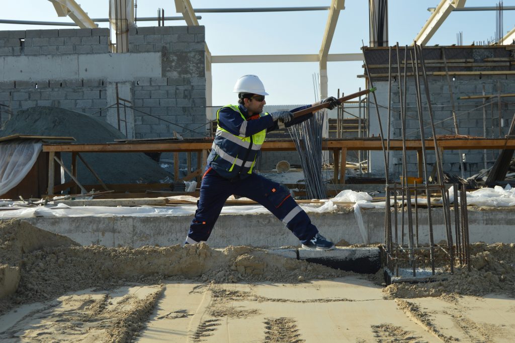 a man in a hard hat holding a gun